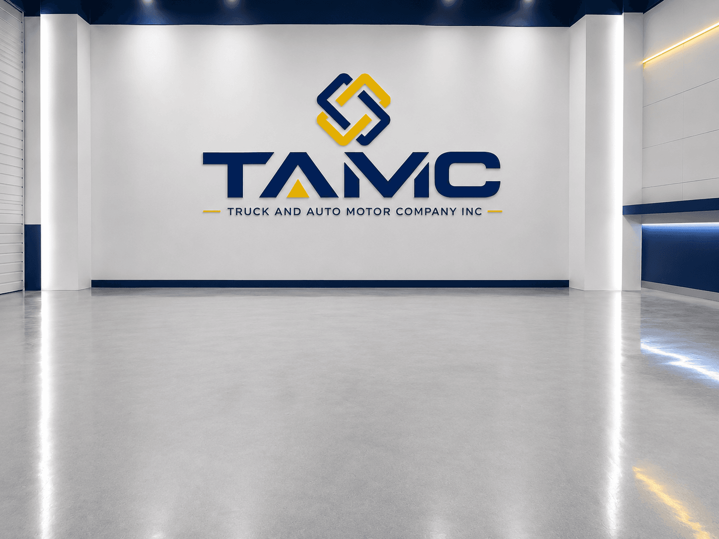 The Truck and Auto Motor Company showroom in Charlotte, NC with the TAMC logo on the wall